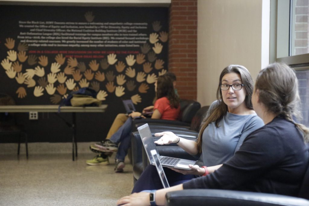 Two SUNY Oneonta faculty members having a conversation with one another. 